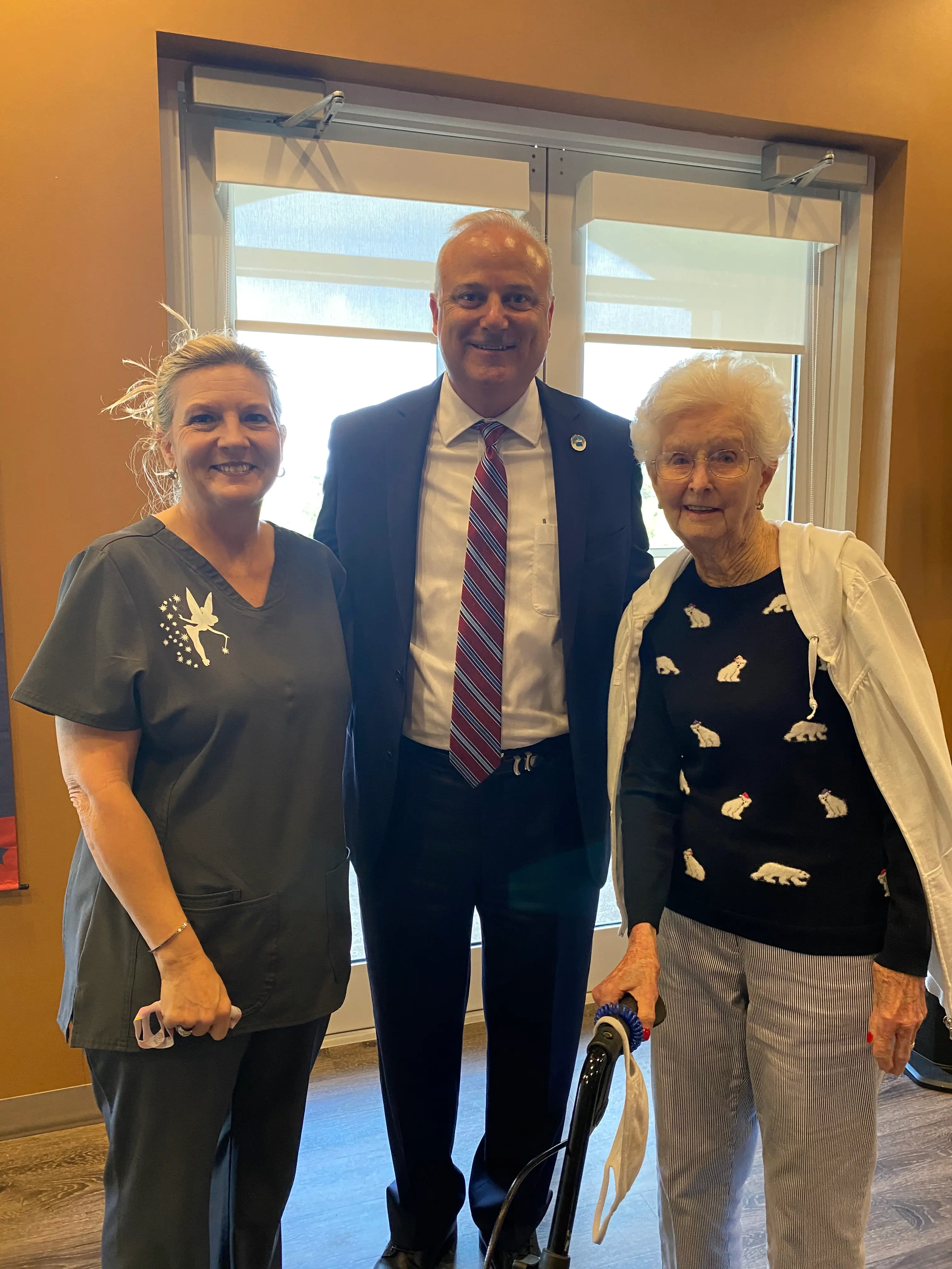 Deneen smiling in a picture with two clients
